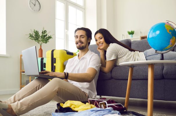 Portrait,Of,Happy,Young,Couple,On,Sofa,In,Living,Room