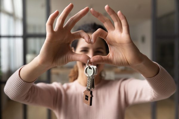 Happy,Smiling,Homeowner,Woman,Pose,In,Living,Room,Hold,Keys